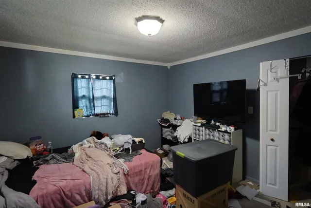 a bedroom with two beds and a flat screen tv