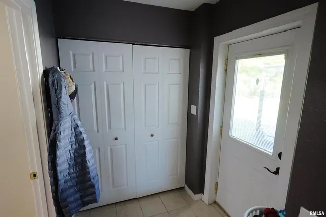 a view of a closet with wooden door
