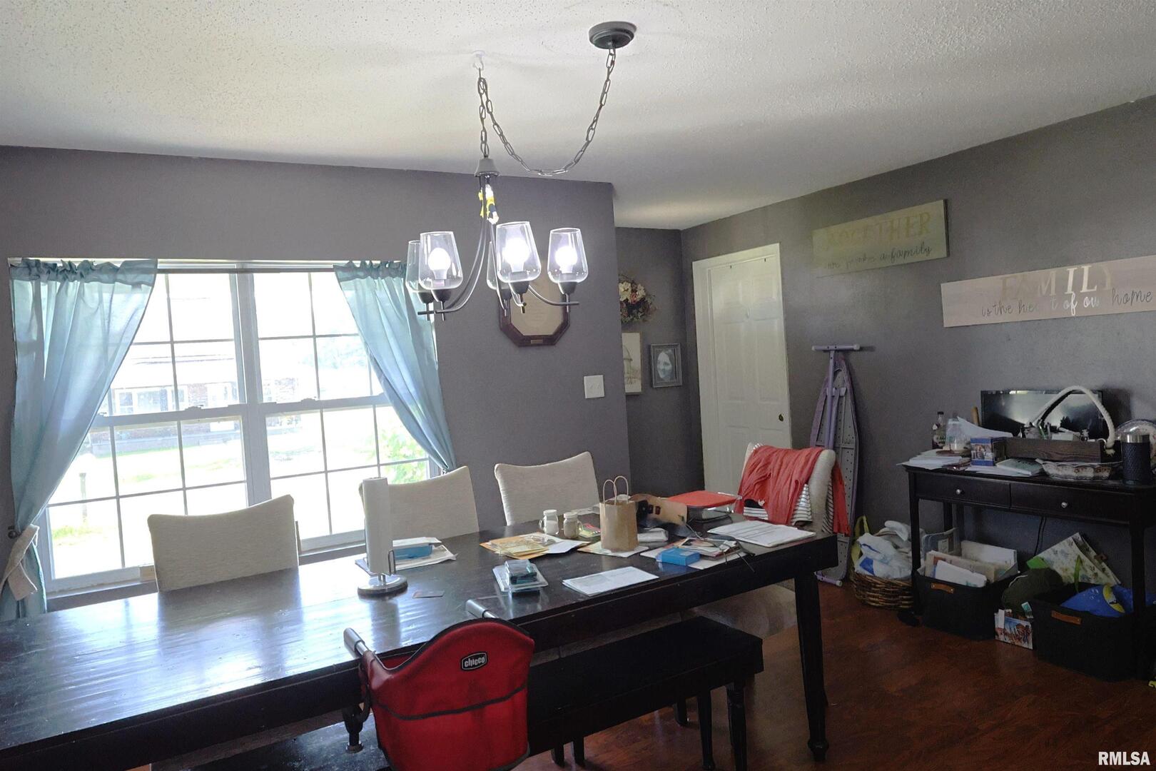 290 West 3rd Street Bonnie, IL 62816 - Photo 9 of 28 a view of a dining room with furniture a chandelier and wooden floor