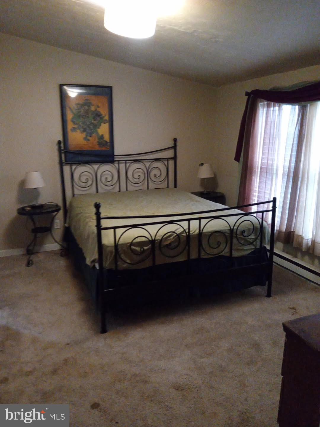 68 Mountain Road Augusta, WV 26704 - Photo 6 of 23 a bed sitting in a bedroom next to a window
