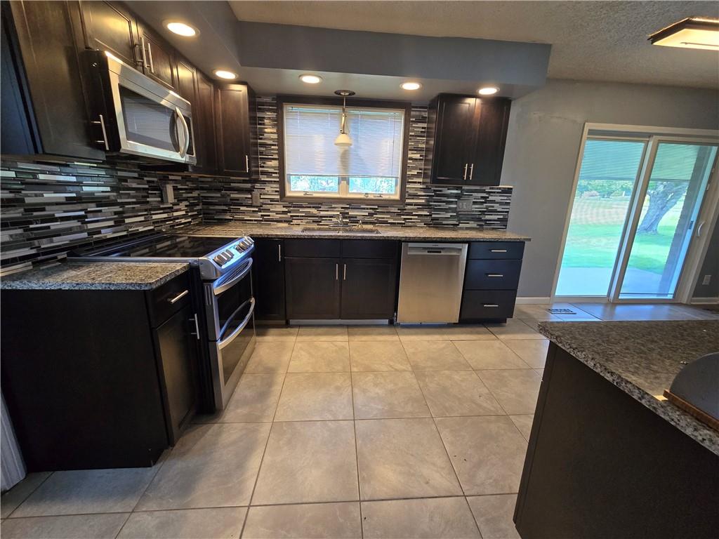 740 South Keel Ridge Road Hermitage, PA 16148 - Photo 6 of 33 a kitchen with stainless steel appliances granite countertop wooden cabinets a sink and a stove
