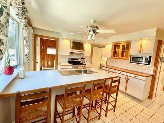 42 Smiths Lane Kingston, MA 02364 - Photo 3 of 39 a kitchen with stainless steel appliances a stove a sink and a refrigerator