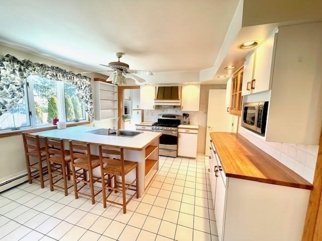 42 Smiths Lane Kingston, MA 02364 - Photo 4 of 39 a kitchen with stainless steel appliances kitchen island granite countertop a sink and cabinets