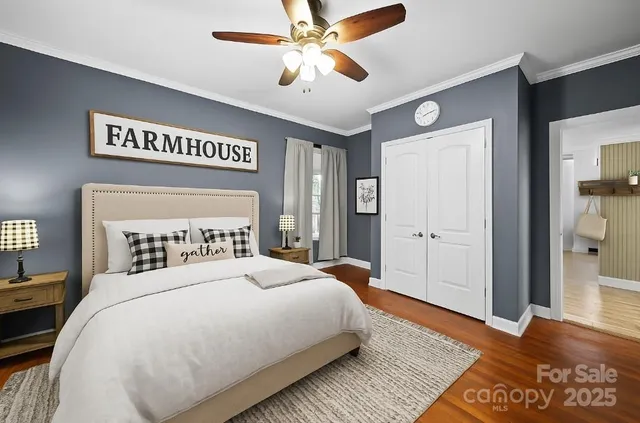 a bedroom with a large bed and a chandelier