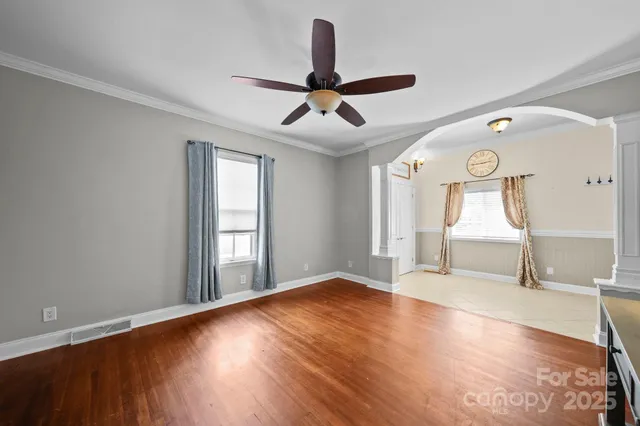 a view of empty room with wooden floor