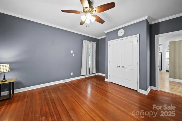 a view of kitchen with kitchen island stainless steel appliances wooden floor and window
