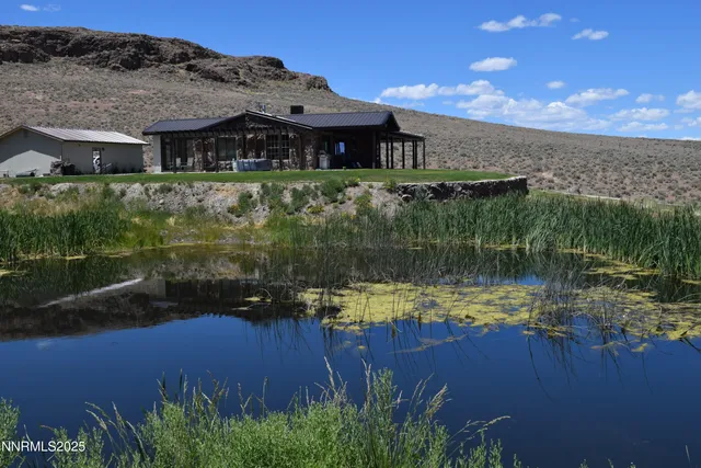 a view of a big yard with a mountain in the background