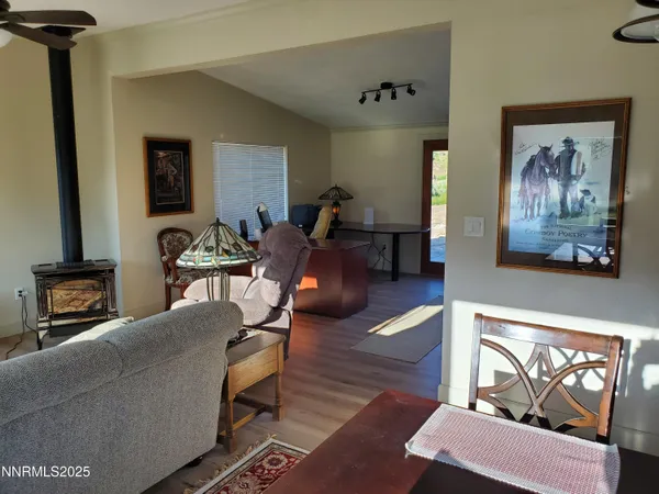 a view of a dining room with furniture and a window