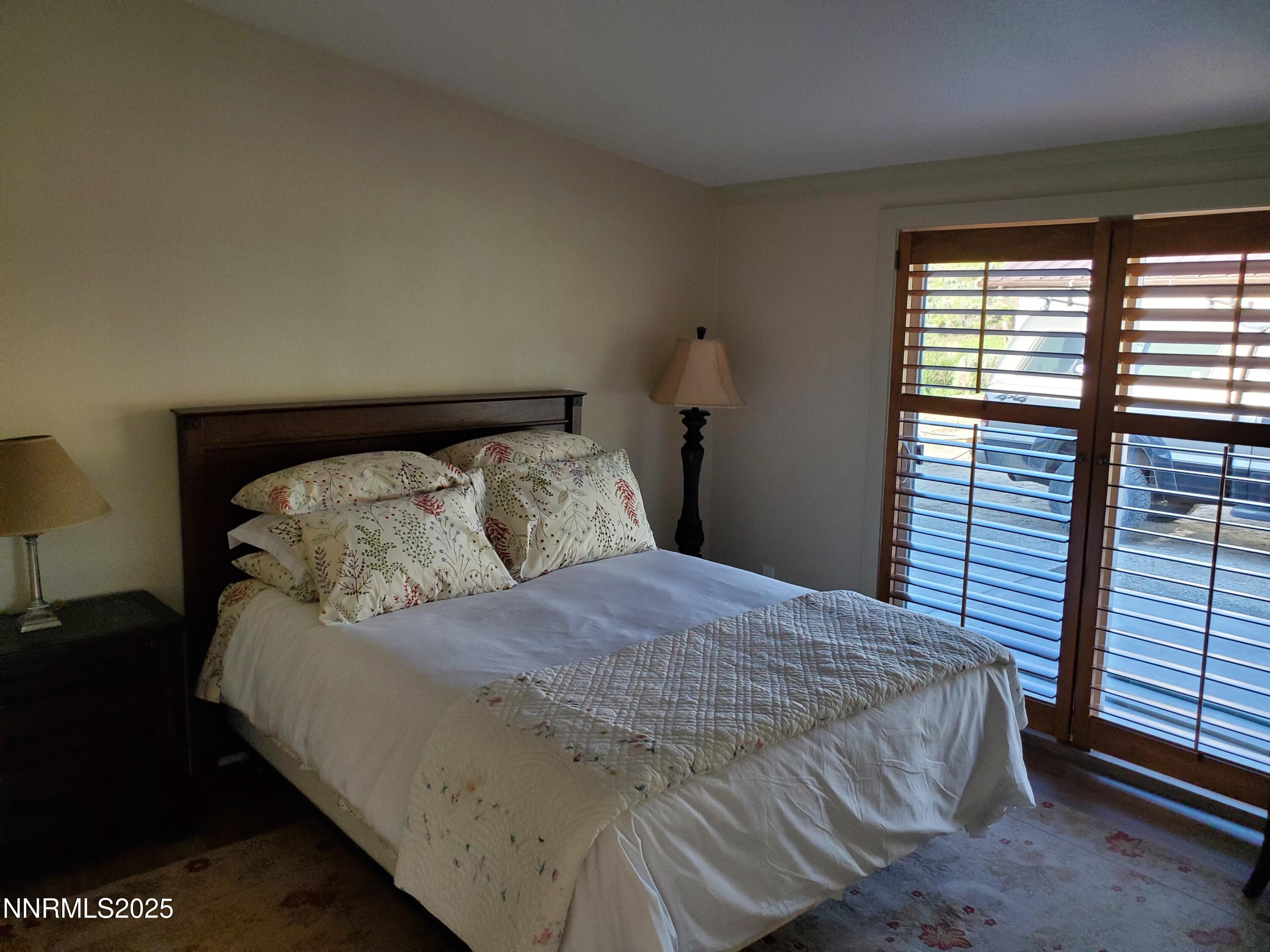 3300 High Rock Road Gerlach, NV 89412 - Photo 27 of 57 a bed sitting in a bedroom next to a window