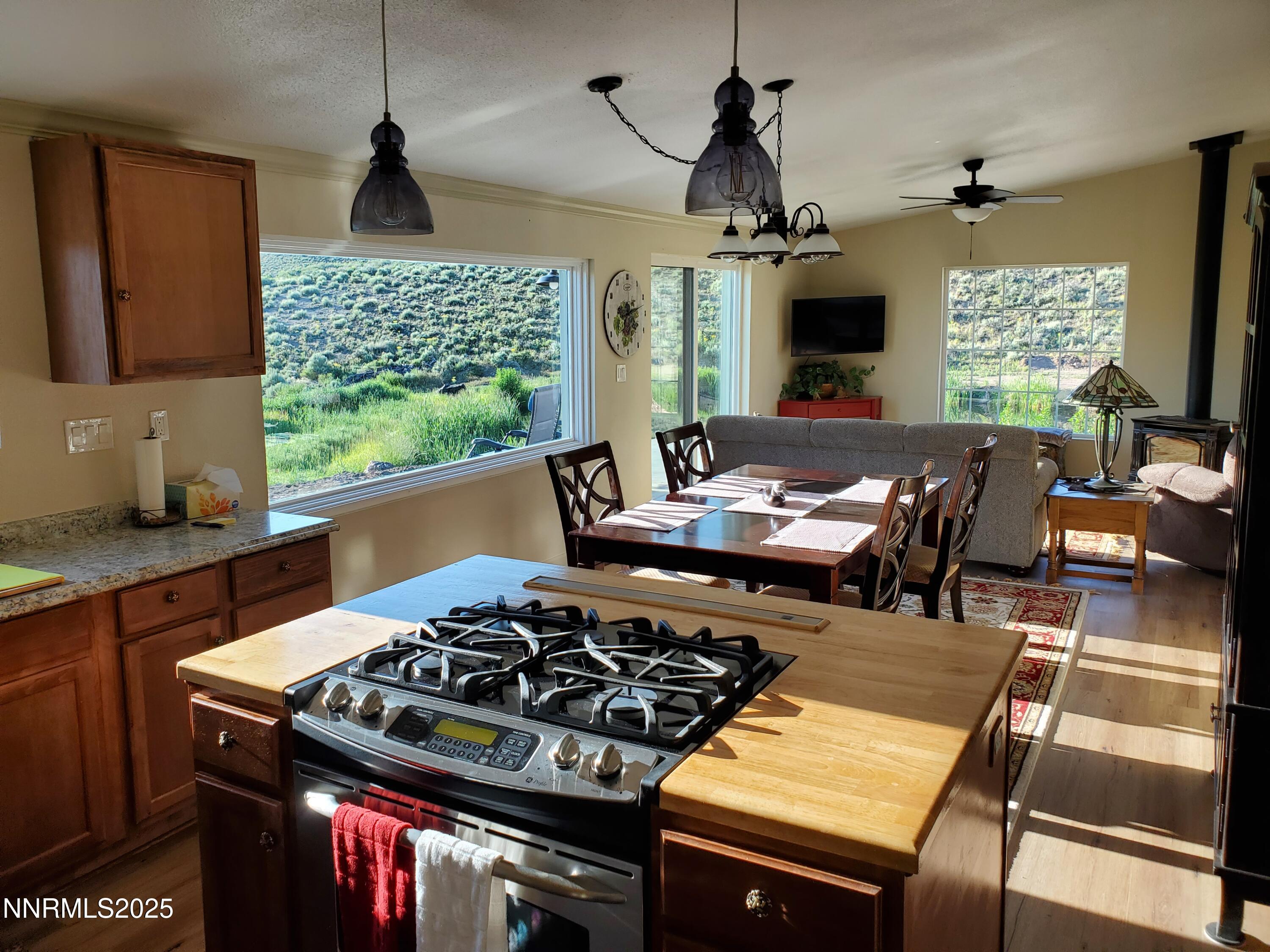 3300 High Rock Road Gerlach, NV 89412 - Photo 30 of 57 a kitchen with a stove a sink a window and dining table