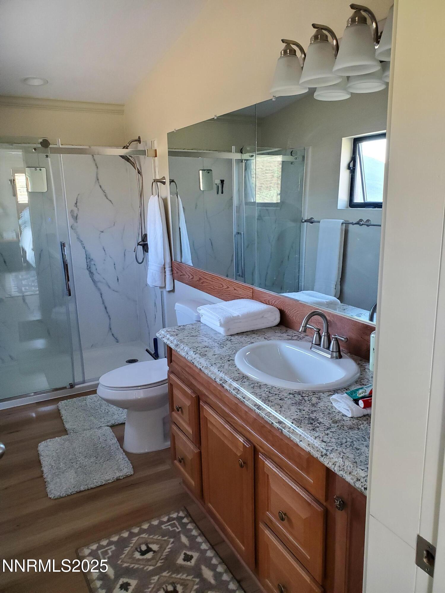 3300 High Rock Road Gerlach, NV 89412 - Photo 31 of 57 a bathroom with a granite countertop sink a toilet and a shower
