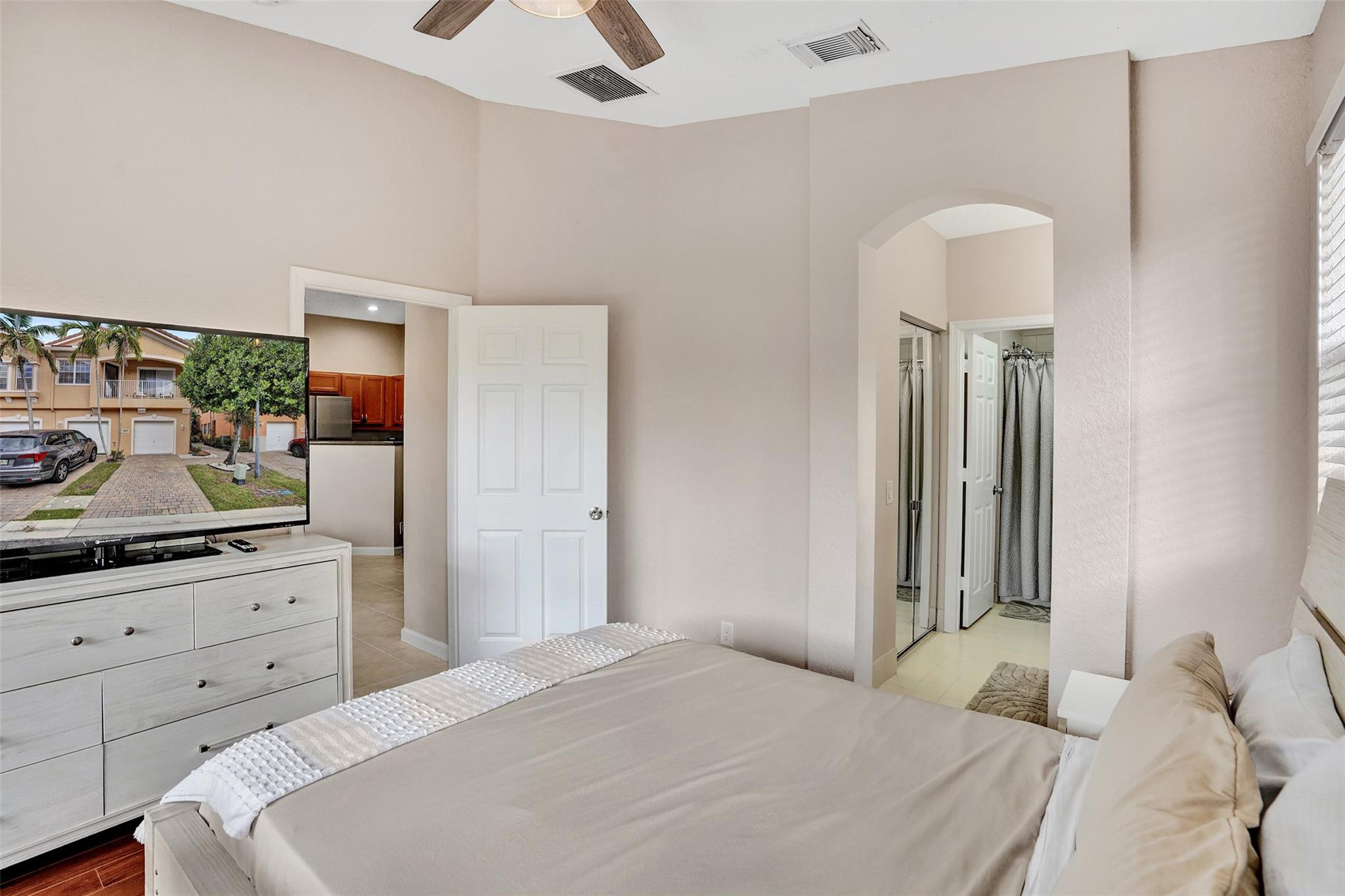 1825 Sonrisa Street Riviera Beach, FL 33404 - Photo 18 of 50 a bedroom with a bed and a potted plant on the dresser
