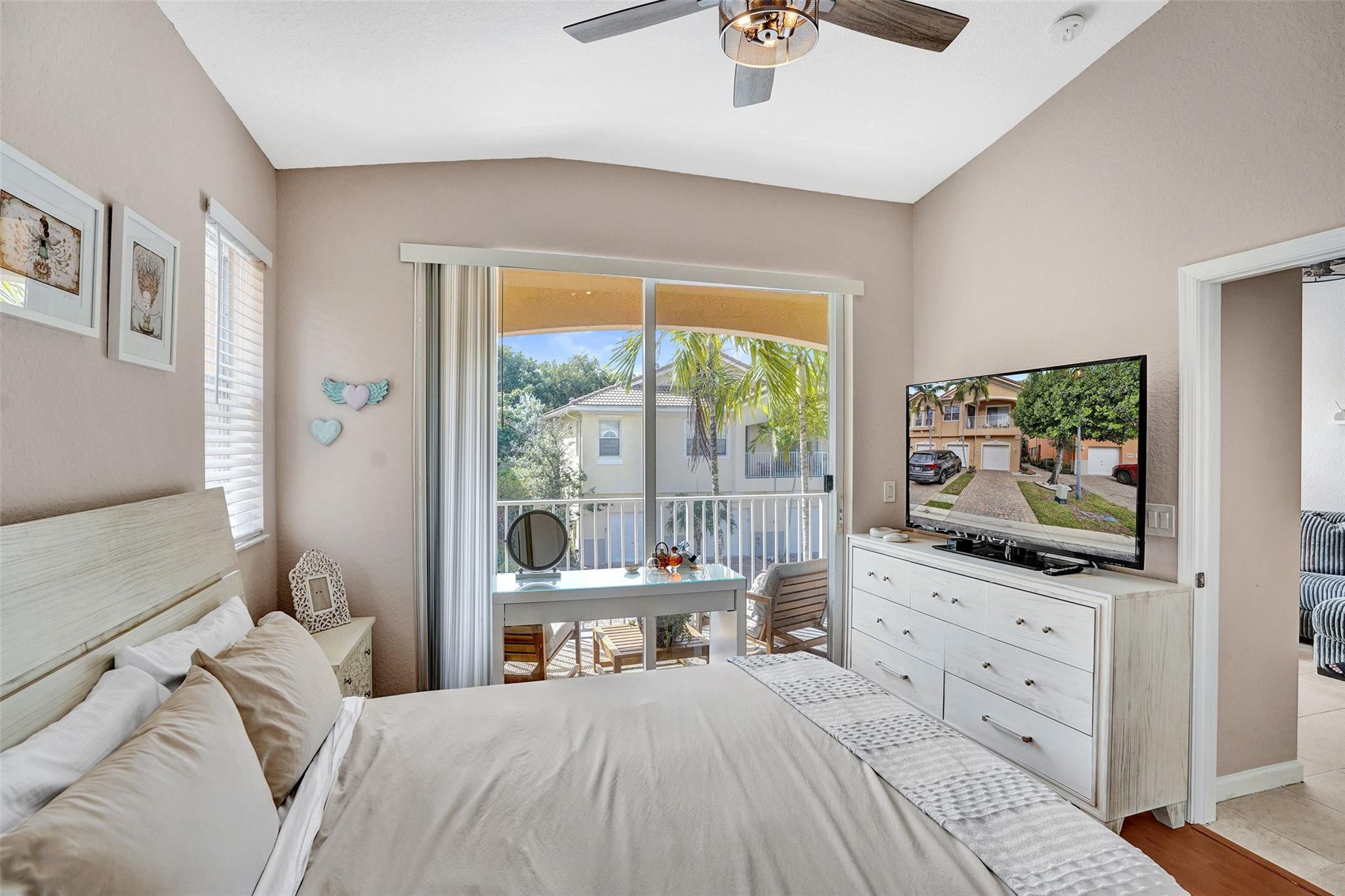 1825 Sonrisa Street Riviera Beach, FL 33404 - Photo 19 of 50 a bedroom with a bed and a flat screen tv