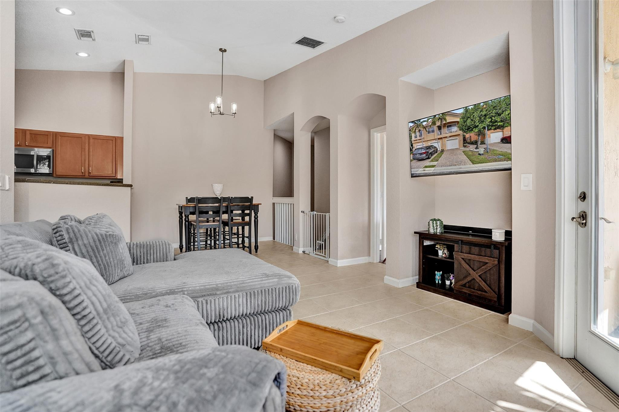 1825 Sonrisa Street Riviera Beach, FL 33404 - Photo 2 of 50 a living room with furniture and a flat screen tv