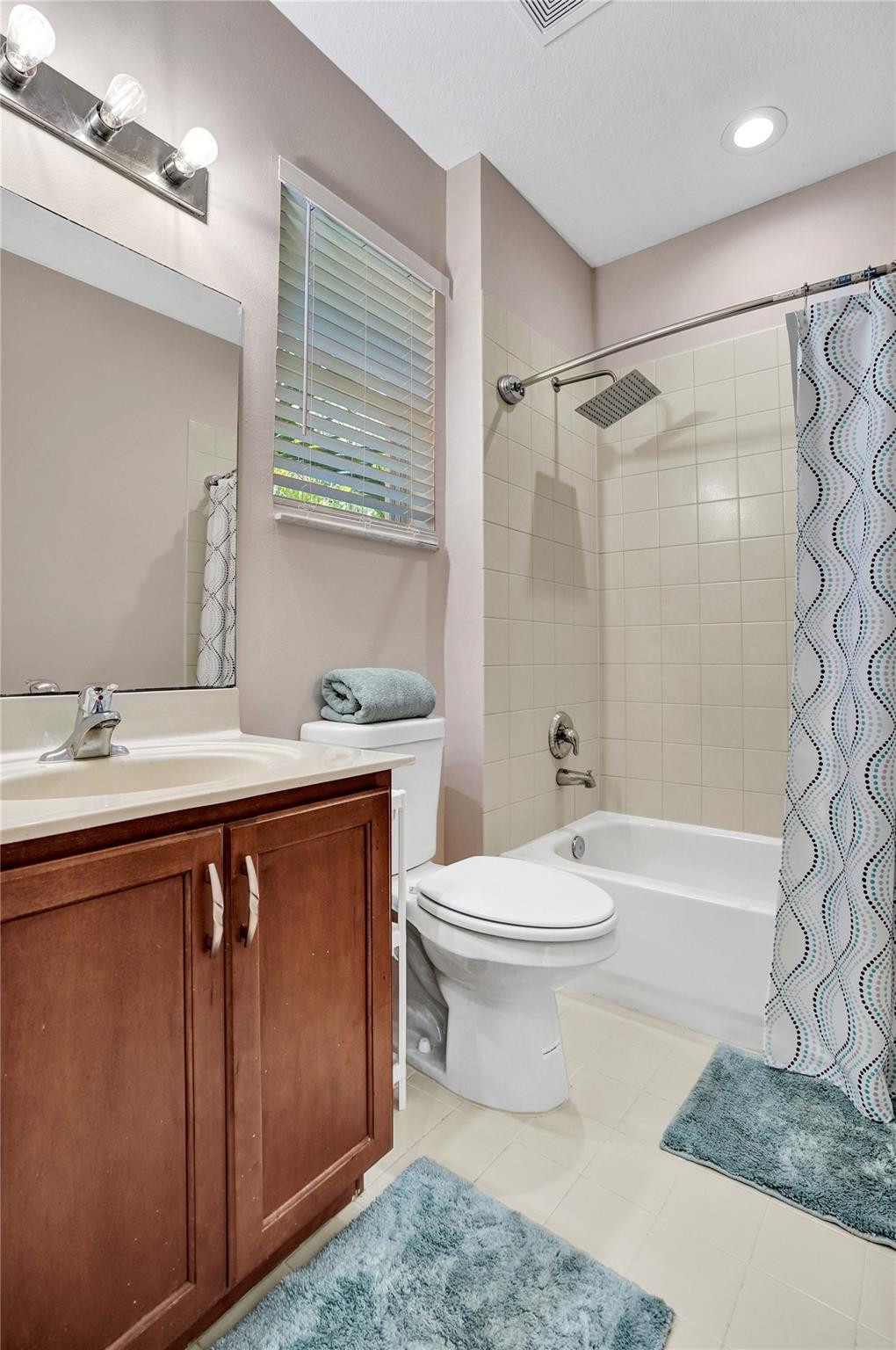1825 Sonrisa Street Riviera Beach, FL 33404 - Photo 24 of 50 a bathroom with a sink a toilet and shower