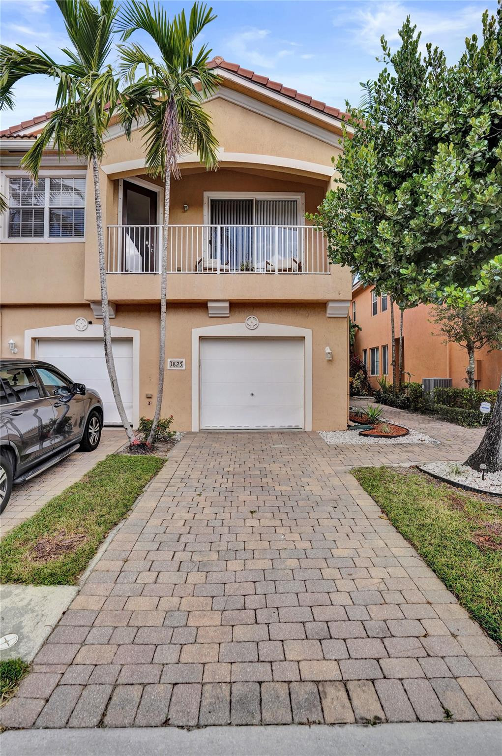 1825 Sonrisa Street Riviera Beach, FL 33404 - Photo 31 of 50 a front view of a house with a yard and garage