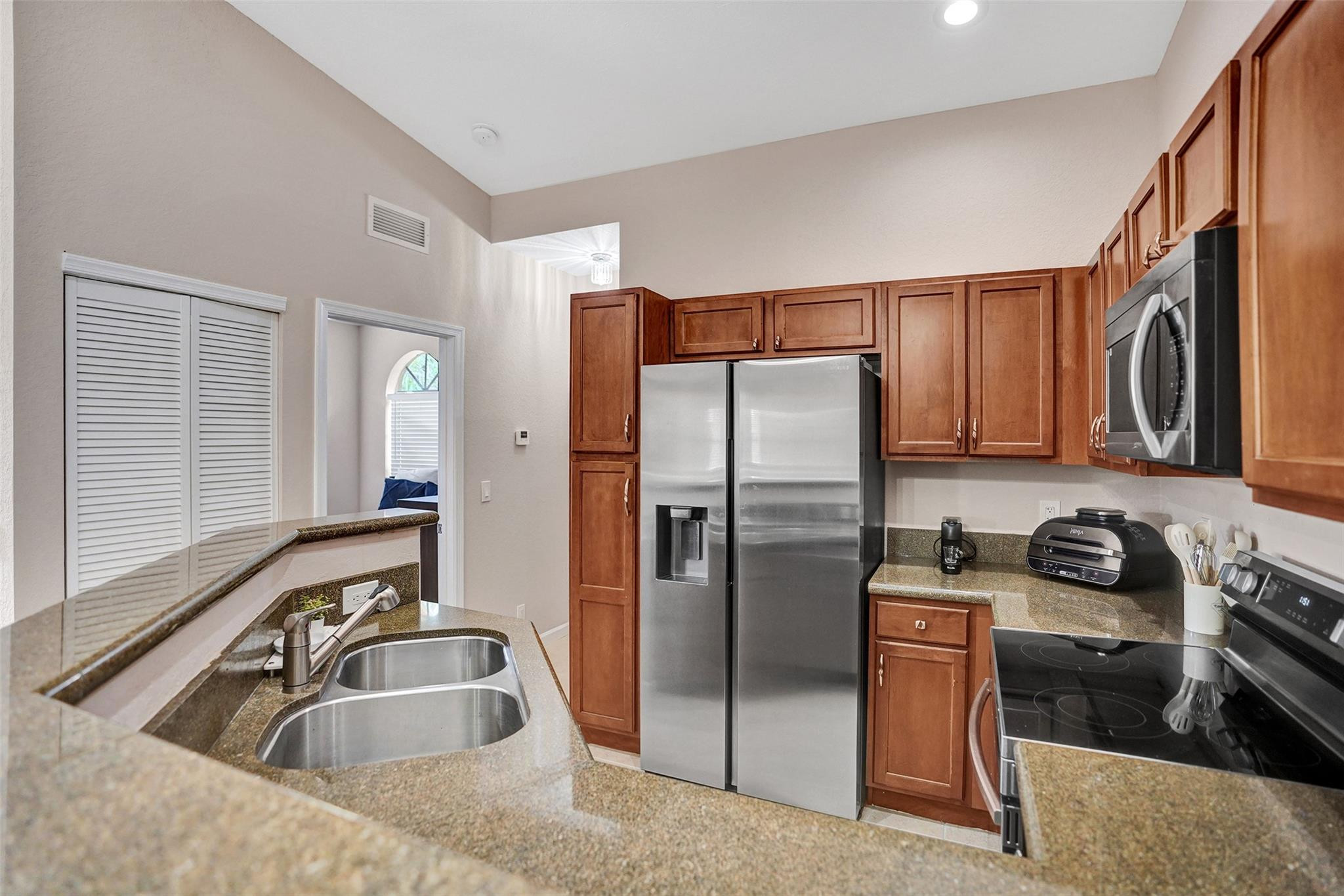 1825 Sonrisa Street Riviera Beach, FL 33404 - Photo 5 of 50 a kitchen with a refrigerator stove and sink
