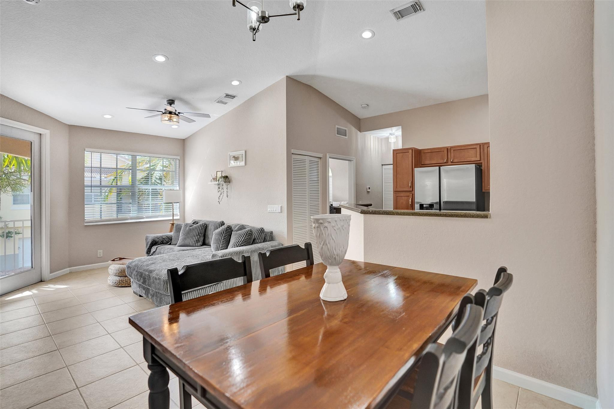 1825 Sonrisa Street Riviera Beach, FL 33404 - Photo 9 of 50 a living room with stainless steel appliances furniture a dining table and a chandelier