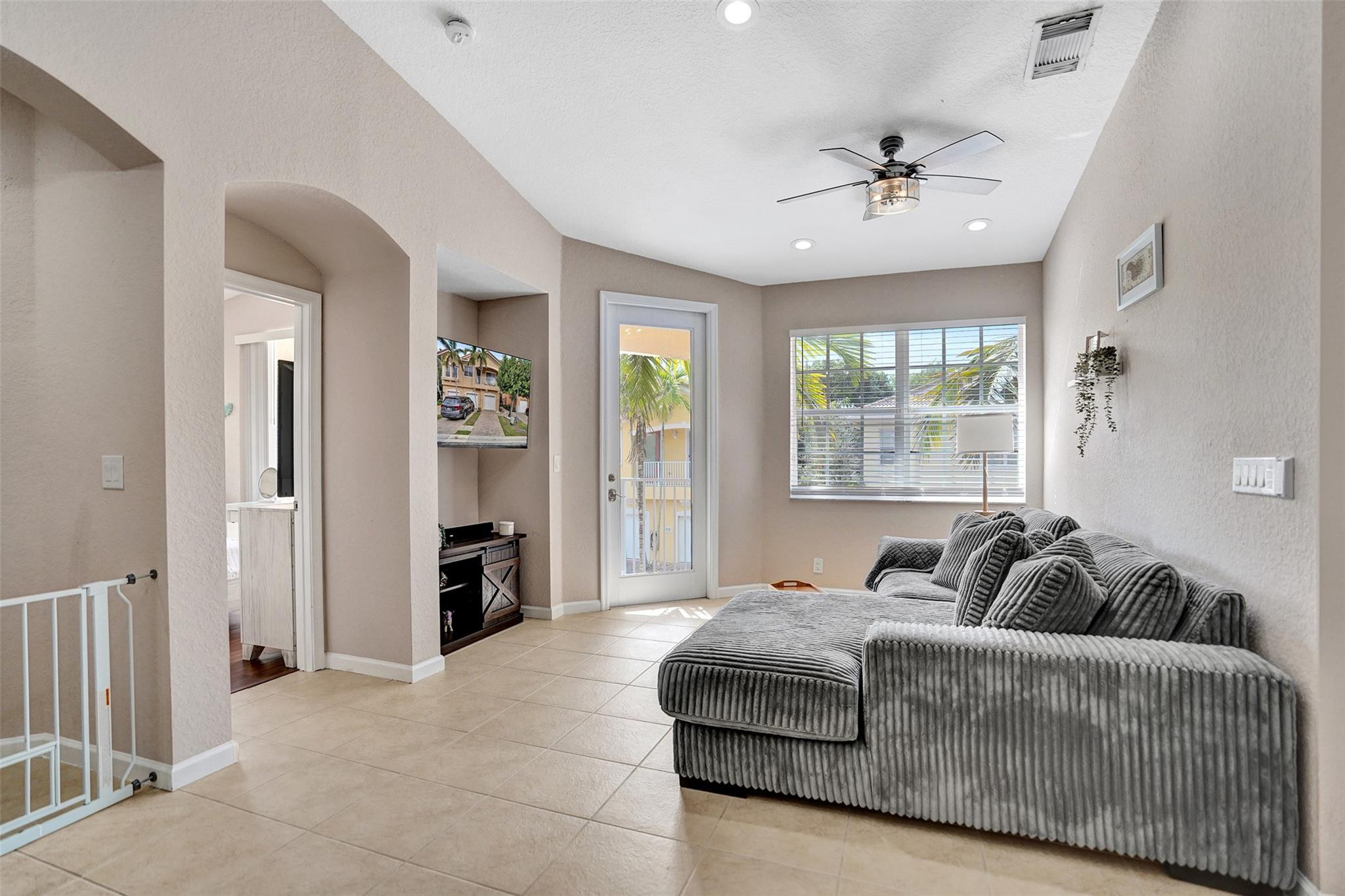 1825 Sonrisa Street Riviera Beach, FL 33404 - Photo 10 of 50 a living room with furniture and a chandelier