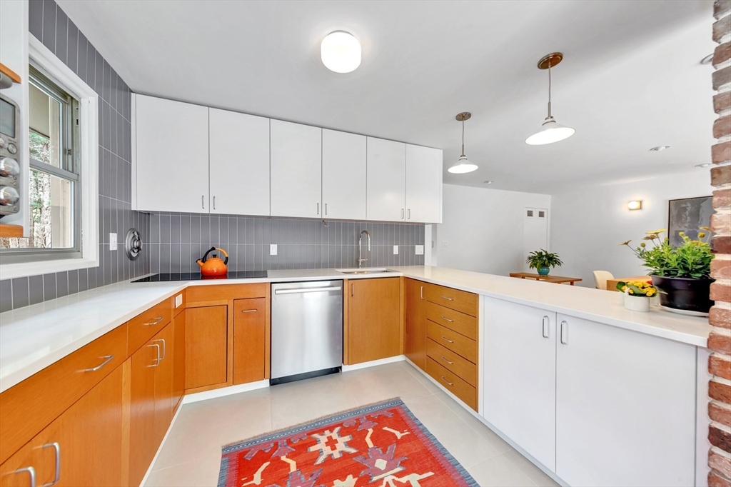 85 The Valley Road Concord, MA 01742 - Photo 6 of 38 a kitchen with stainless steel appliances granite countertop a sink dishwasher and white cabinets with wooden floor