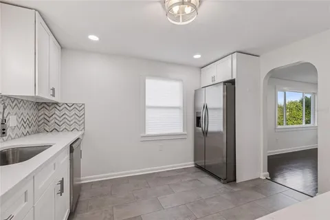 a kitchen with a sink and refrigerator
