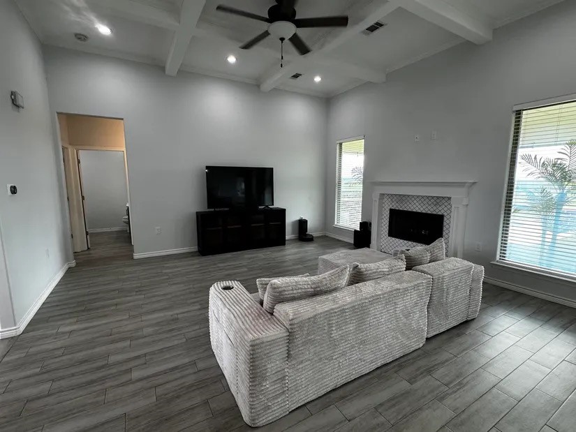 2295 Diamond D Lane Beaumont, TX 77713 - Photo 5 of 40 a living room with furniture a fireplace and a flat screen tv