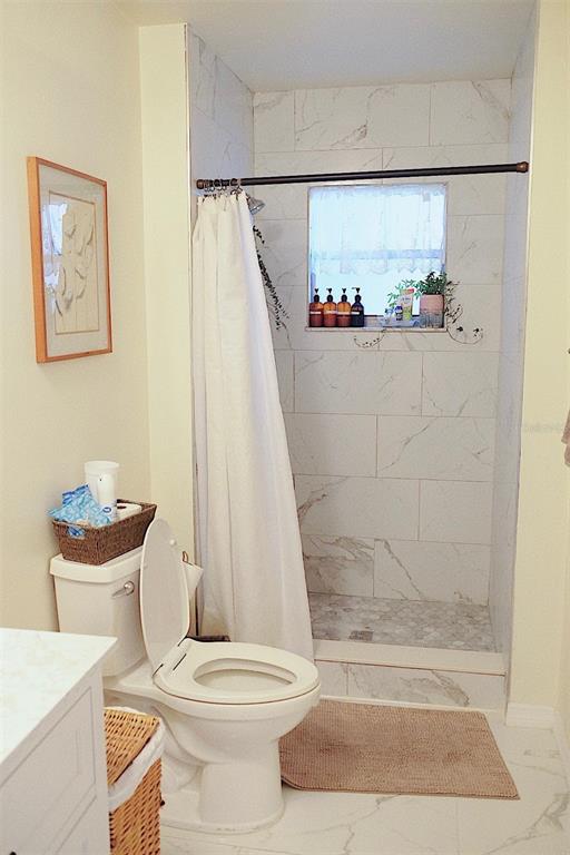10659 Windsor Court Orlando, FL 32821 - Photo 11 of 15 a bathroom with a toilet and a shower