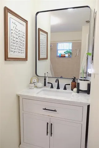 a bathroom with double sink and a mirror