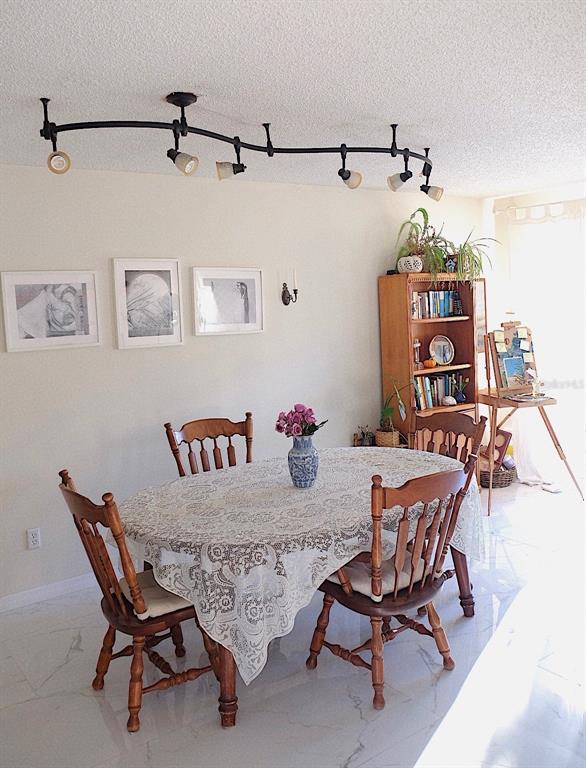 10659 Windsor Court Orlando, FL 32821 - Photo 7 of 15 a dining room with furniture and window