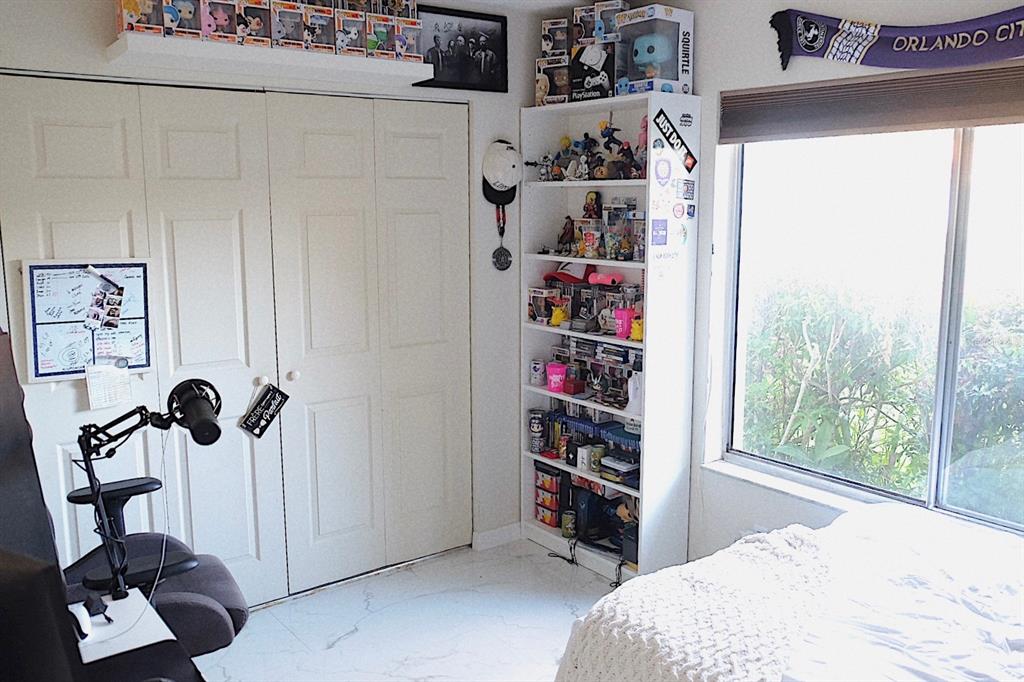 10659 Windsor Court Orlando, FL 32821 - Photo 9 of 15 a bedroom with a bed and a window