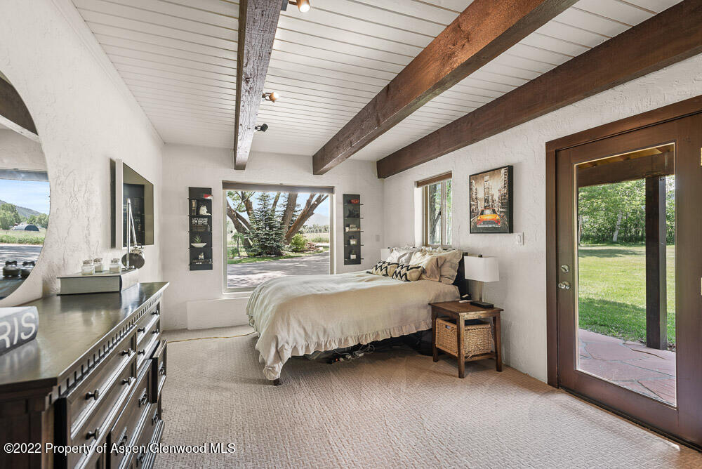 2459 Emma Road Basalt, CO 81621 - Photo 12 of 31 a bed room with a bed and a chair