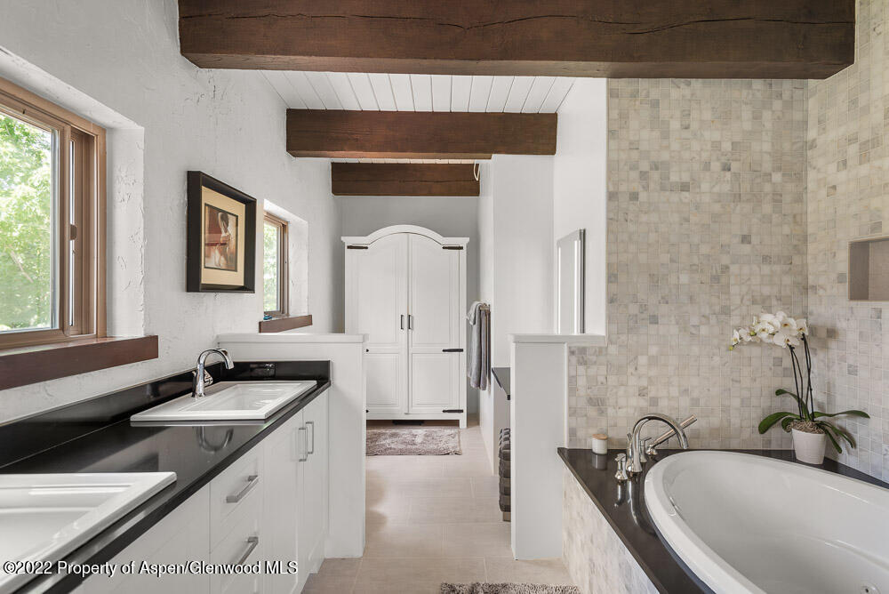 2459 Emma Road Basalt, CO 81621 - Photo 16 of 31 a bathroom with a tub sink and mirror