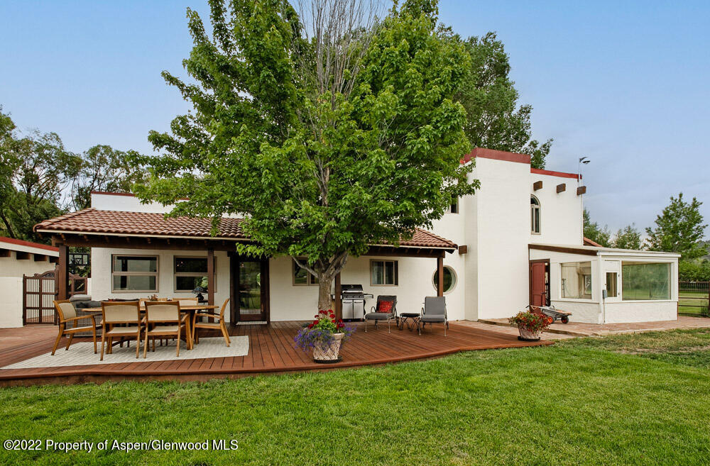 2459 Emma Road Basalt, CO 81621 - Photo 24 of 31 a view of a patio with table and chairs potted plants and large tree