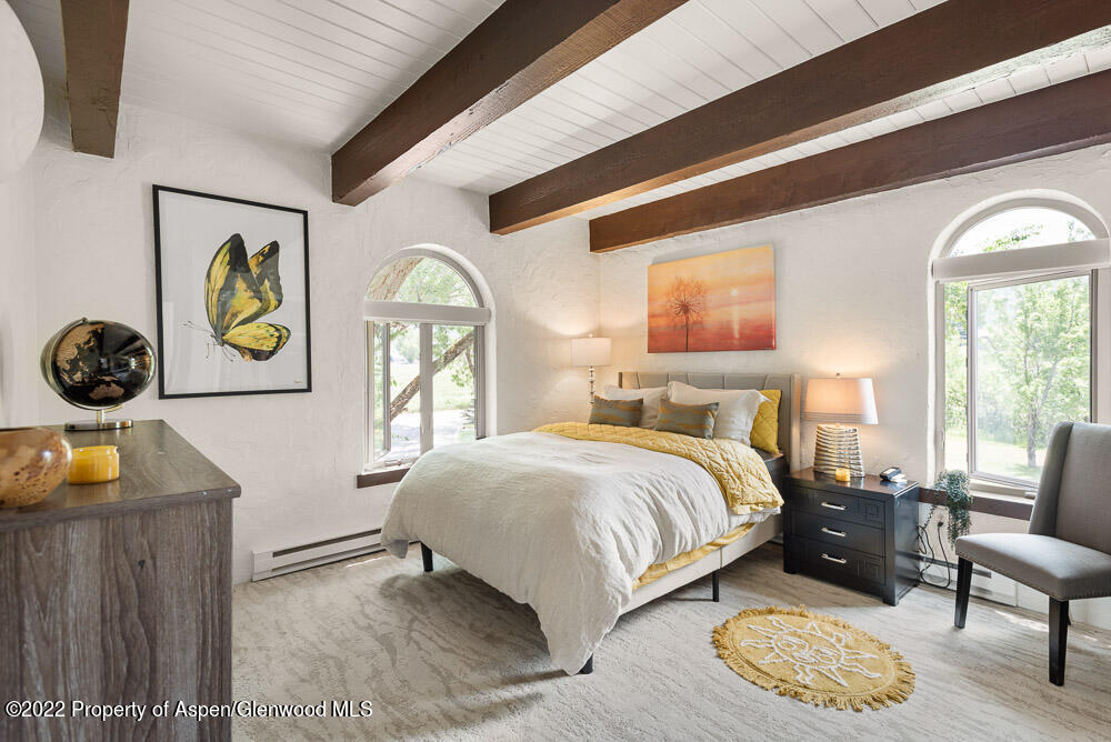 2459 Emma Road Basalt, CO 81621 - Photo 3 of 31 a bedroom with a bed and a painting on the wall