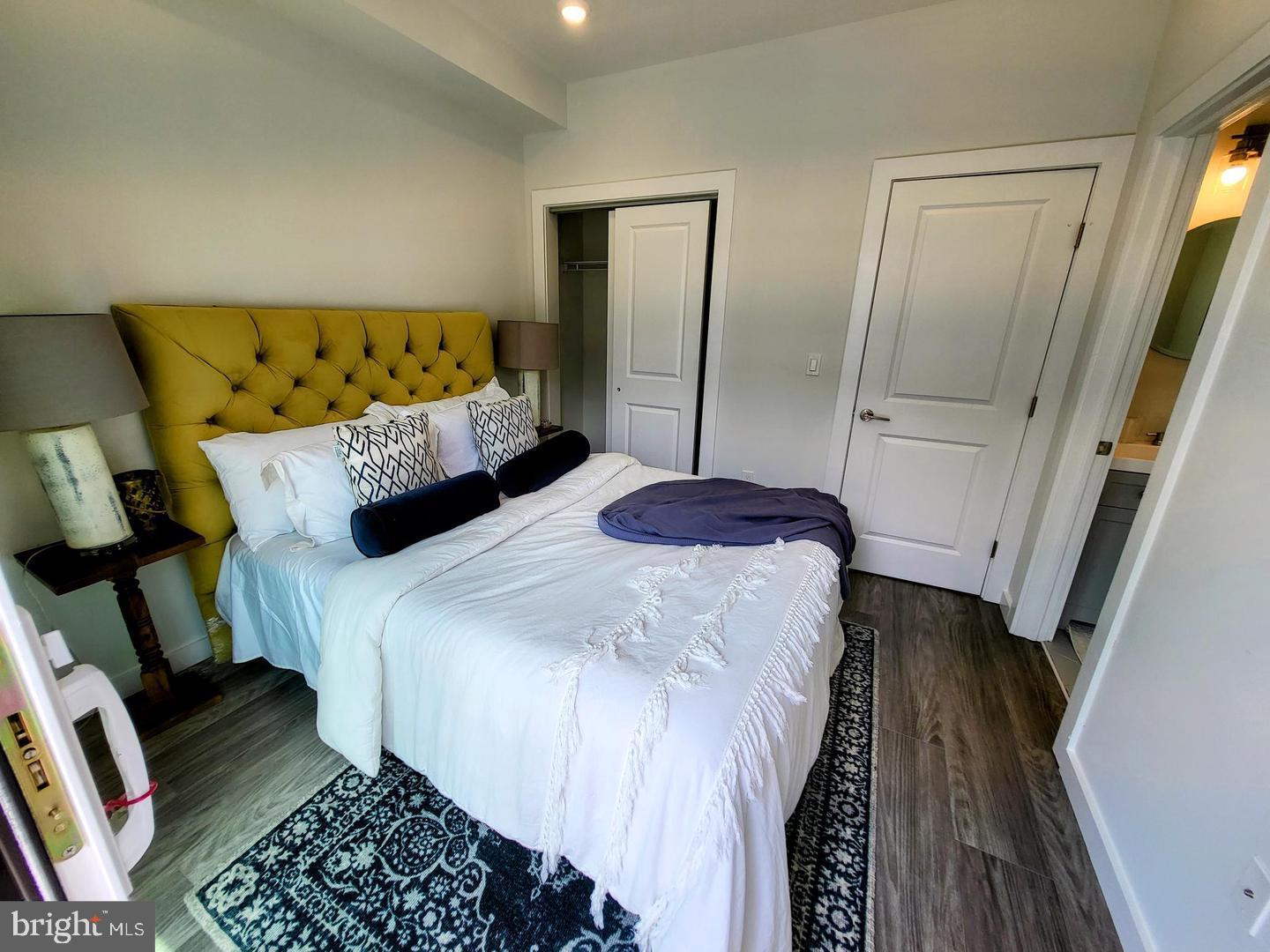 1617-19 Ridge Avenue, Unit K Philadelphia, PA 19130 - Photo 4 of 15 a bedroom with a bed and a mirror on dresser