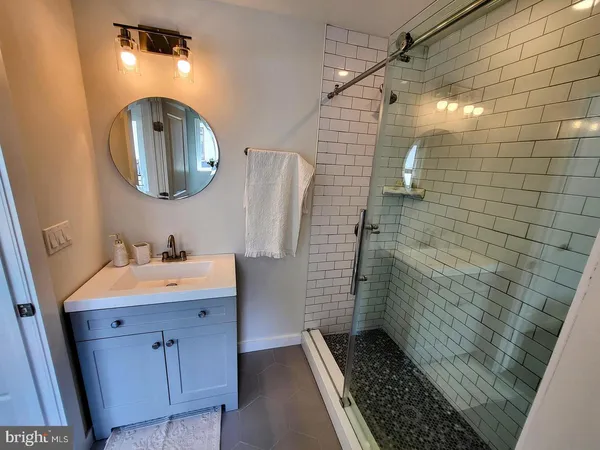 a bathroom with a sink a toilet and mirror