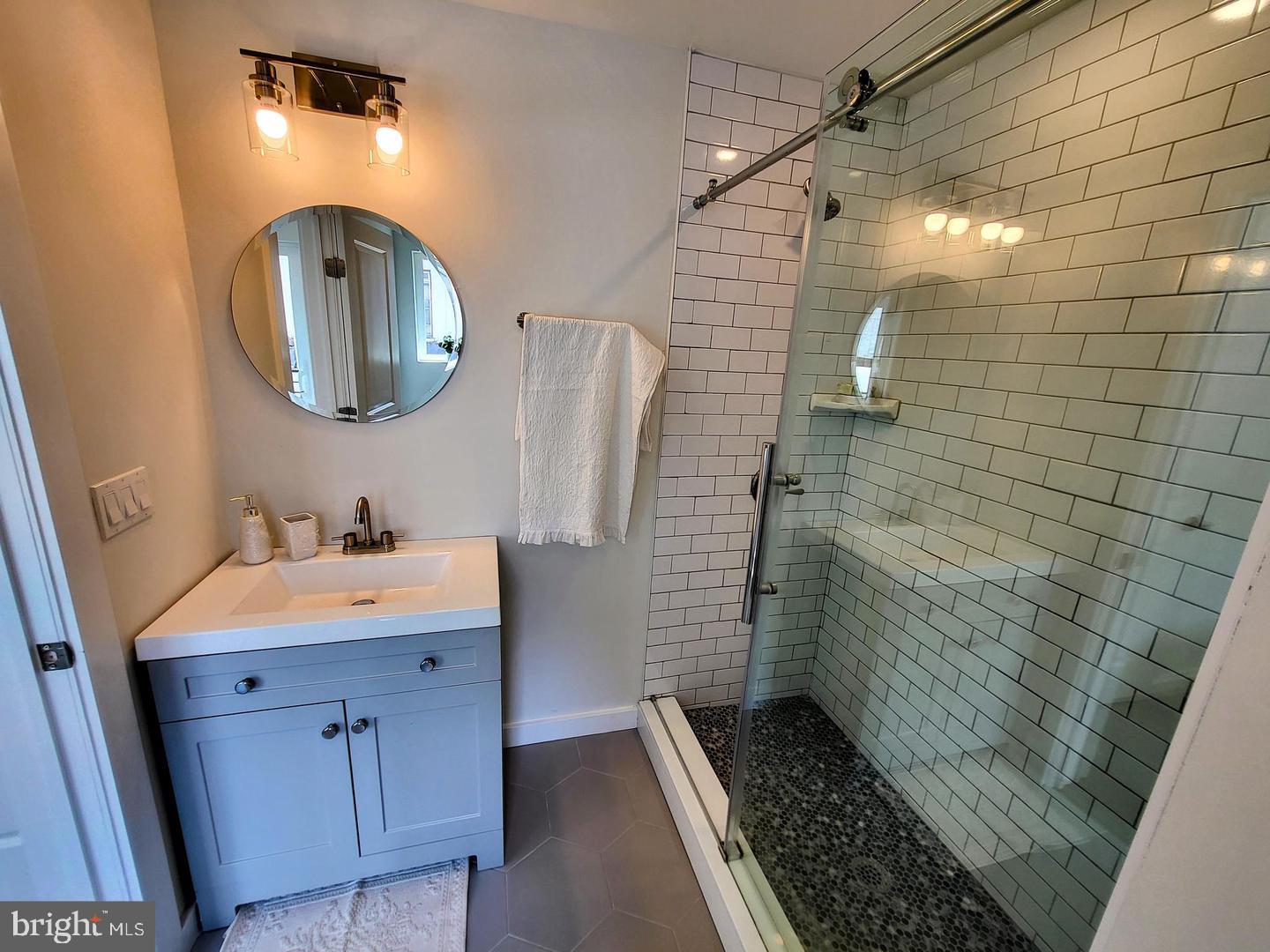 1617-19 Ridge Avenue, Unit K Philadelphia, PA 19130 - Photo 5 of 15 a bathroom with a sink a toilet and mirror