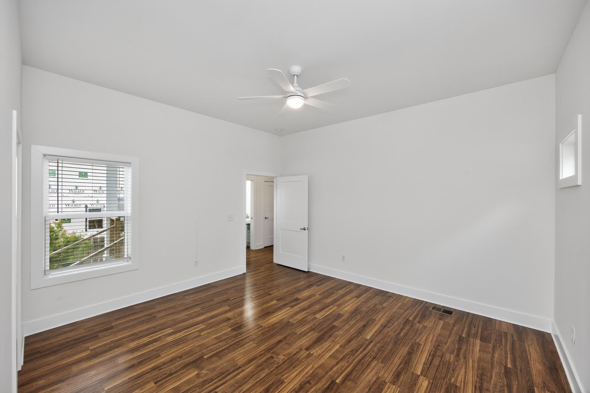 7 Decatur Street Nashville, TN 37210 - Photo 22 of 43 a view of an empty room with wooden floor and a window
