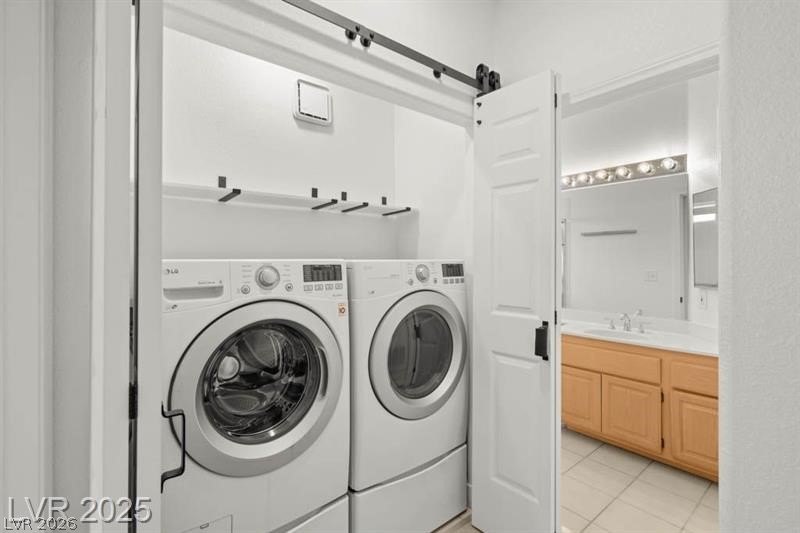 3320 South Fort Apache Road, Unit 125 Las Vegas, NV 89117 - Photo 20 of 26 A clever barn door conceals a convenient laundry area, offering easy access to an adjacent bath.