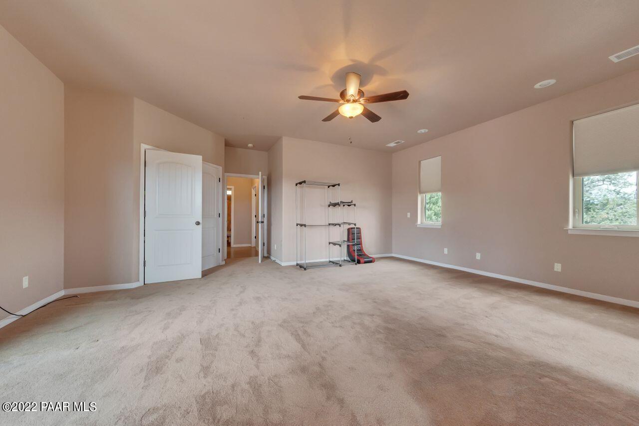 5755 West Rambling Road Prescott, AZ 86305 - Photo 11 of 22 an empty room with windows and fan