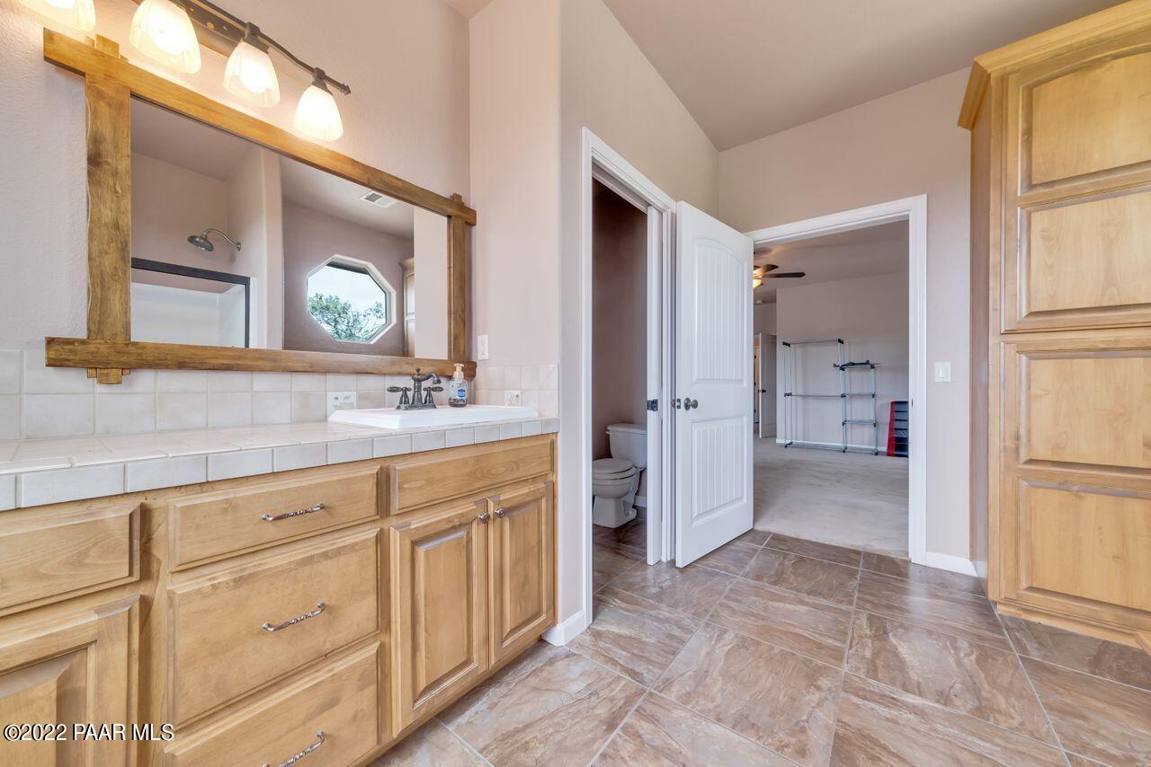 5755 West Rambling Road Prescott, AZ 86305 - Photo 12 of 22 a spacious bathroom with a shower a sink and a mirror