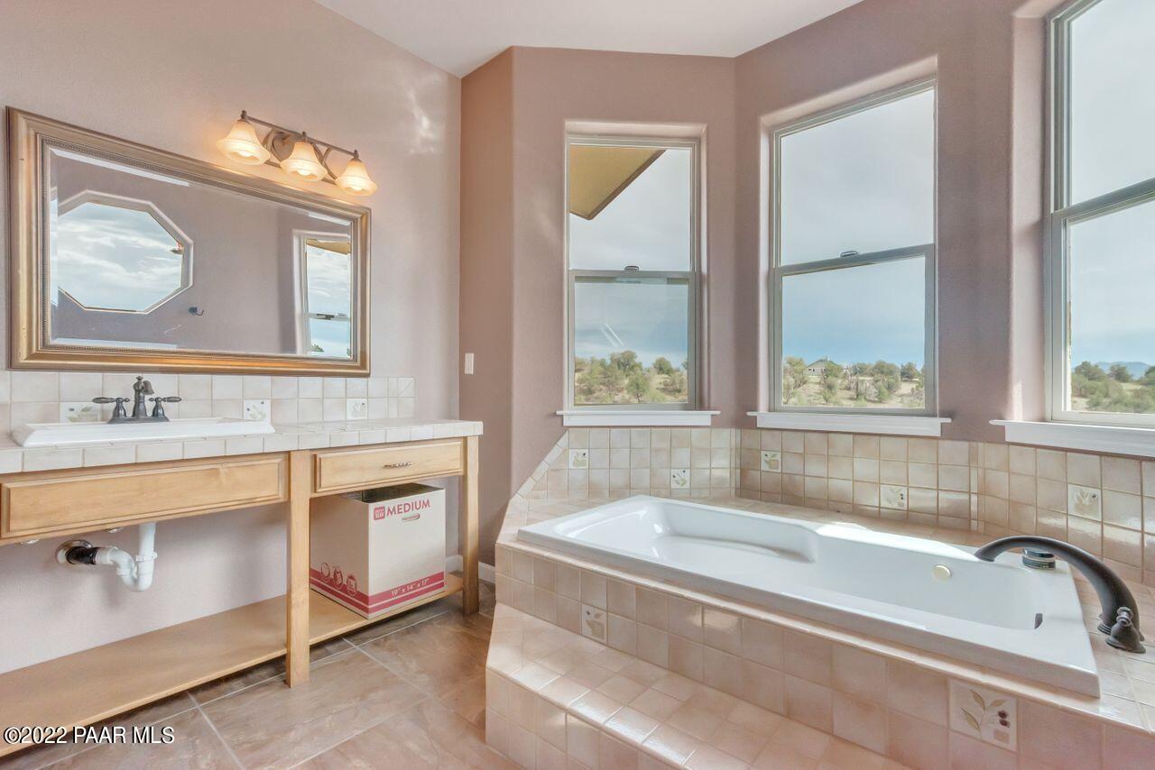 5755 West Rambling Road Prescott, AZ 86305 - Photo 13 of 22 a bathroom with a tub a sink and a window