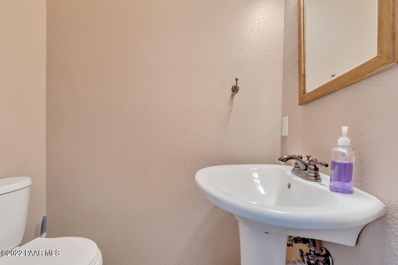 5755 West Rambling Road Prescott, AZ 86305 - Photo 15 of 22 a bathroom with a sink a toilet and mirror