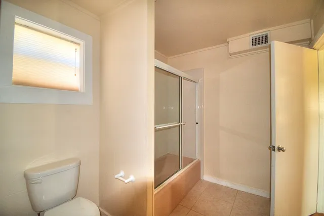 a bathroom with a shower and a toilet