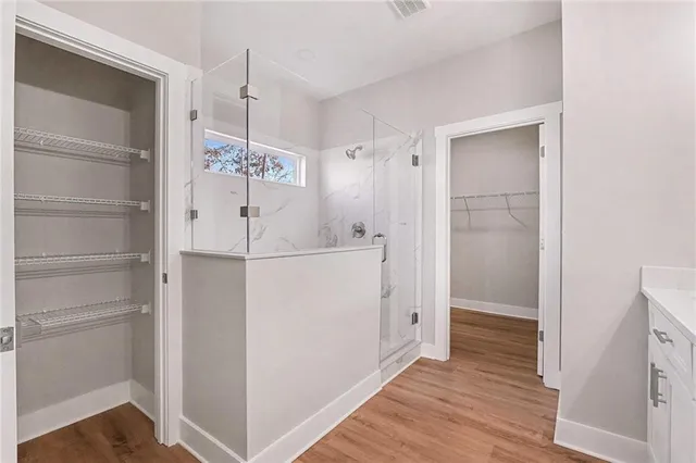 a view of hallway with wooden floor