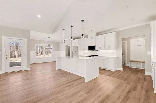 a kitchen with white cabinets and white appliances