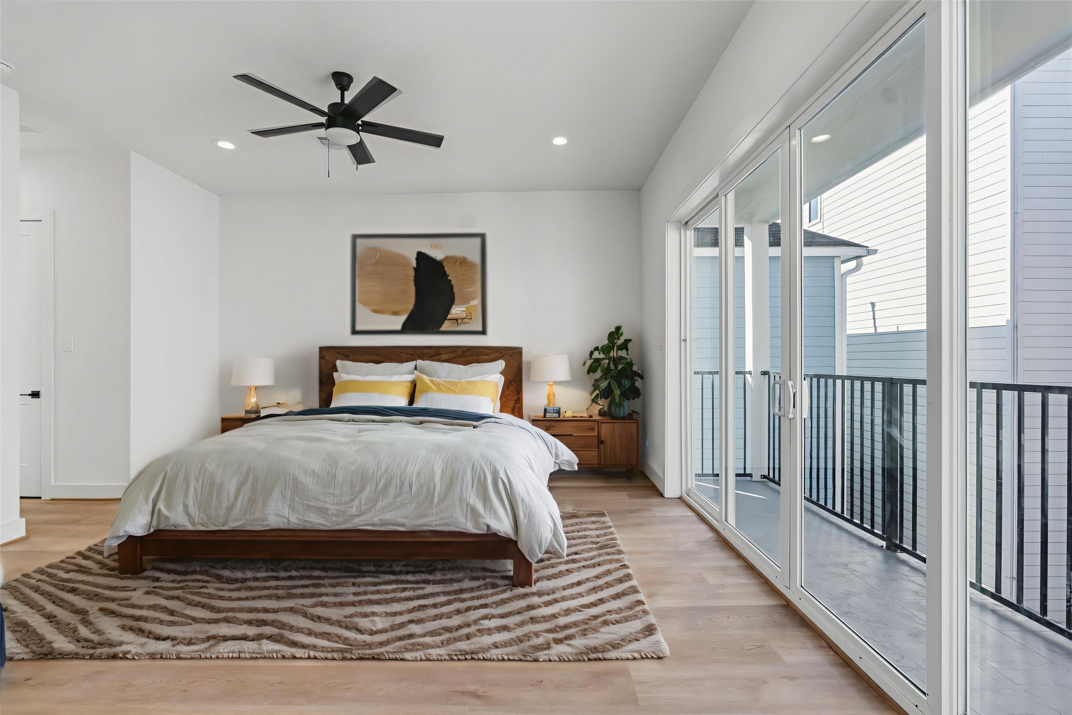 1140 West 16th Street Houston, TX 77008 - Photo 13 of 23 a bedroom with a large bed and a ceiling fan
