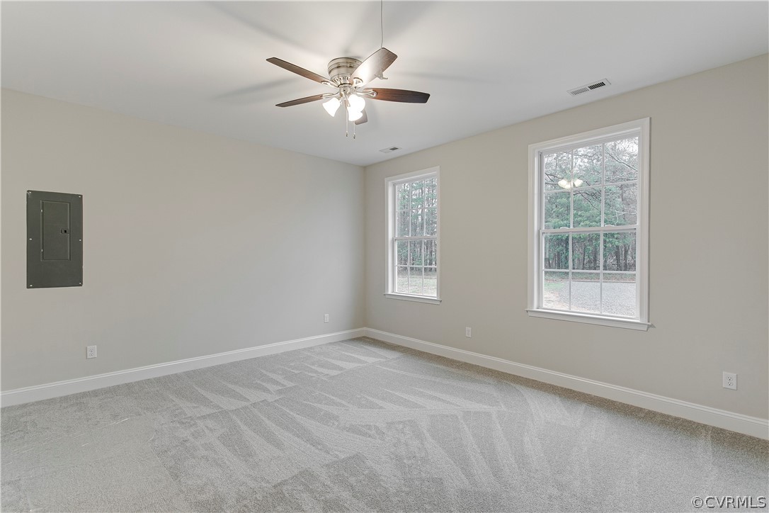 123 Carter Road Cumberland, VA 23040 - Photo 12 of 25 The primary bedroom offers carpet, a ceiling fan, a large wic, and an ensuite bathroom.