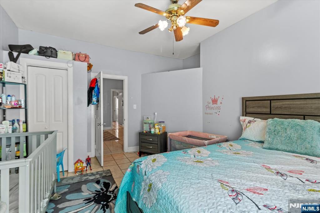 331 Market Street Paterson, NJ 07501 - Photo 19 of 25 a bedroom with a bed and a chandelier