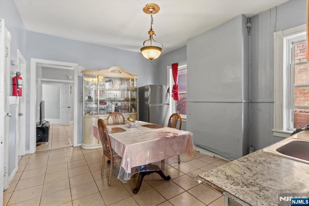 331 Market Street Paterson, NJ 07501 - Photo 22 of 25 a dining room with a chandelier